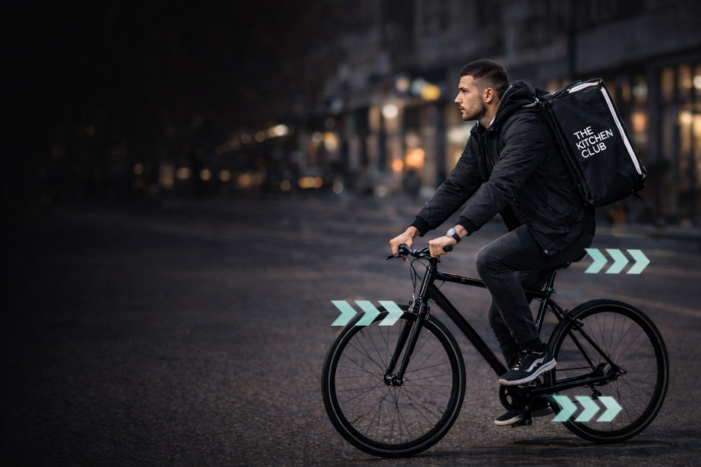 A man delivering food on a bicycle